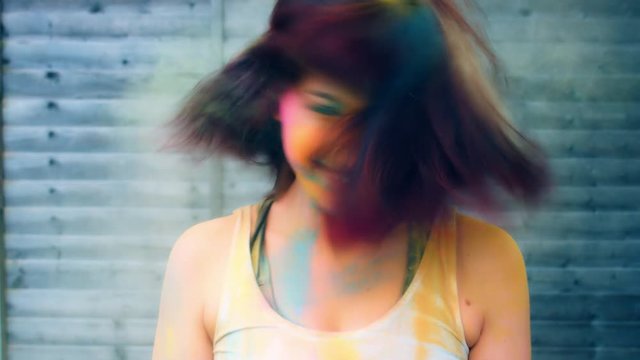 4k Colourful LGBT Shot of a Woman in Holy Powder Shaking her Head