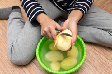 woman peeling potatoes
