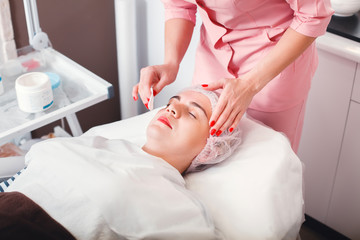 Naklejka premium Young woman getting spa treatment at beauty salon