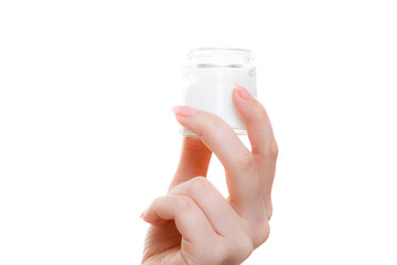 Woman holding cream in little jar package