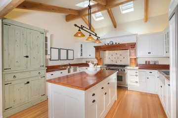 Kitchen interior in new luxury home with kitchen island.