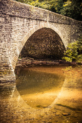 Tranquil scene of an arched stone bridge