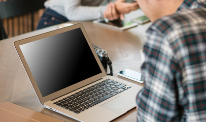 Smart man in casual style using laptop for work in coffee shop cafe.