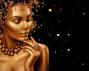 Beauty fashion model girl with golden skin, makeup and hairstyle isolated on black background