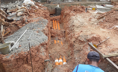 SELANGOR, MALAYSIA -NOVEMBER 03, 2014: Underground utilities trenches. Construction workers digging...