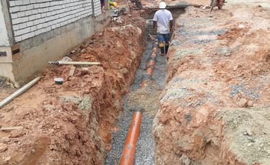 SELANGOR, MALAYSIA -NOVEMBER 03, 2014: Underground utilities trenches. Construction workers digging...
