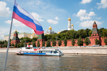 Russian flag on background of Moscow Kremlin and Moscow River