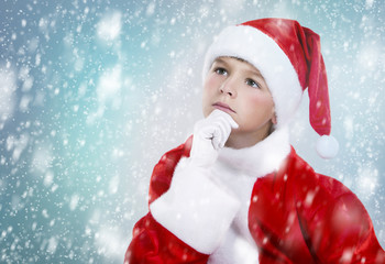 boy dressed up as Santa in winter setting