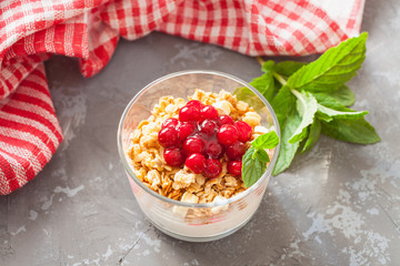 yogurt, muesli and berries in a glass on a table, selective focus