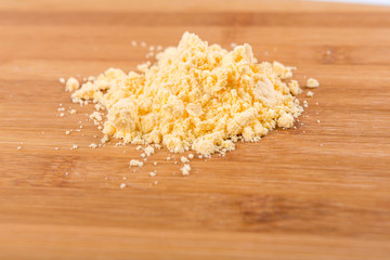 Cheese powder mix isolated on wood background
