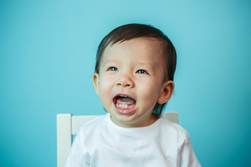 Portrait of sad crying baby girl on white