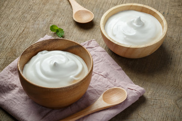 Homemade yogurt or sour cream in a wooden bowl