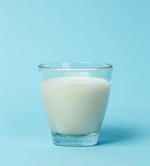 Milk glass over blue background