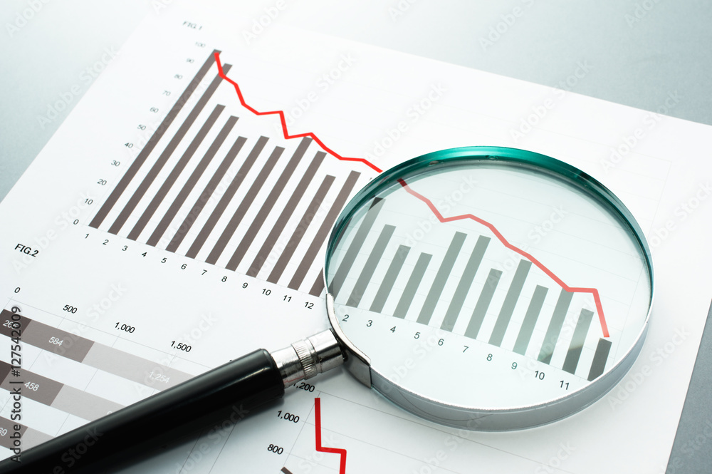 Poster reviewing financial report. looking at decrease chart with magnifying glass. document, chart and mag
