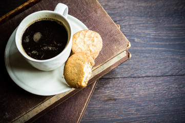 Cup of coffee on dark wooden table