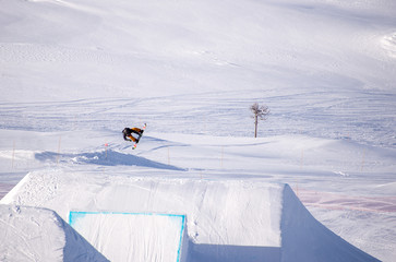 Snowboarder spinning doing a grab in the air