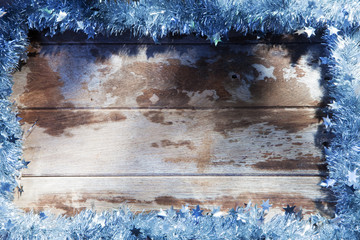 close up view of christmas tree garland on wooden back