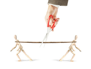Man cuts a rope which two men pull in different directions. Get rid from competition. Abstract image with wooden puppet