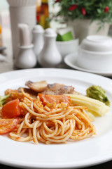 Fried Spaghetti and grilled fish on white dish.