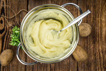 Mashed Potatoes (selective focus) on vintage wooden background