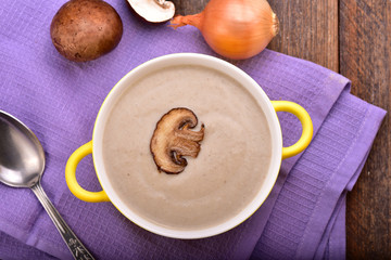 Mushroom cream soup on the wooden table. Top view.
