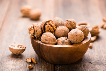 Walnuts in wooden bowl on table. Nuts.