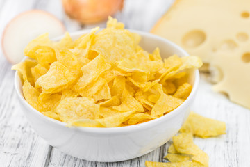 Cheese and Onion Potato Chips (selective focus) on vintage woode