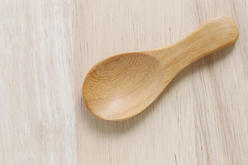 Wooden spoon on brown old wood table.