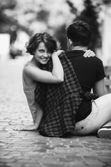 man and woman sitting on the ground