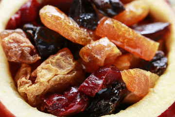 Red christmas apple stuffed with dried fruits in honey