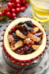 Red christmas apple stuffed with dried fruits in honey