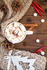 Coffee with marshmallows. Christmas decorations. Wooden background.