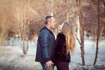 A man and a woman in the Park standing opposite each other, horizontal.