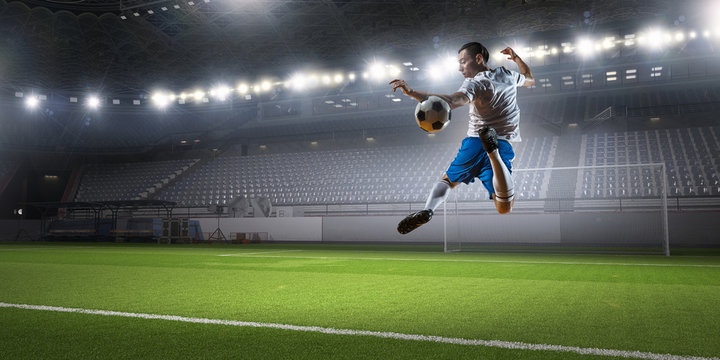 Soccer player kicking ball . Mixed media