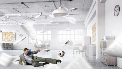 Playing office soccer . Mixed media