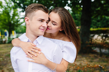 Young adult brunette man and woman in the park