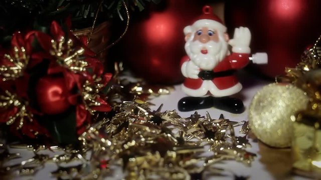 Dancing Toy Santa Claus. Santa gets light from flashing Christmas lights