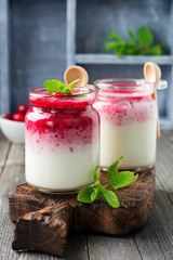 Healthy breakfast. Fresh cranberry smoothie in a glass jar on the old wooden background. Selective focus.