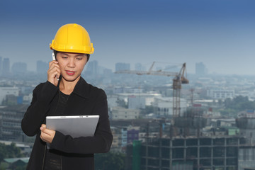 women engineers was on the phone to communicate on cityscape bac