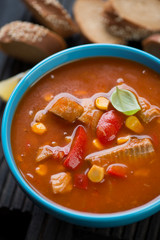 Soup with tilapia, bell peppers, sweet corn and potato, close-up