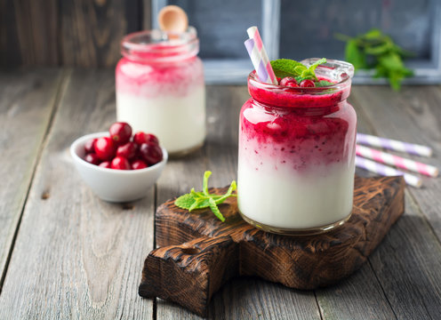 Healthy breakfast. Fresh cranberry smoothie in a glass jar on the old wooden background. Selective focus.