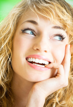 Portrait of thinking young attractive woman, indoors