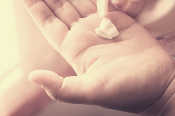Close up of hands with skin lotion.