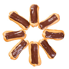 Homemade eclairs with chocolate cream on the white table.