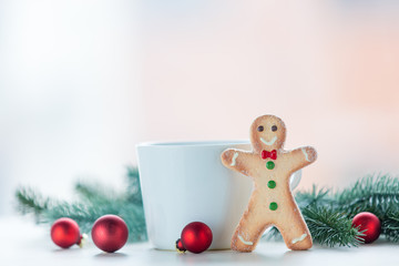Obraz na płótnie Canvas Gingerbread man with cup and christmas