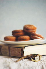 cookies on a white plate on a old book