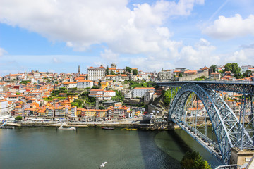 Fototapeta na wymiar View of the historic city of Porto, Portugal with the Dom Luis bridge and blue sky / Ancient city Porto,metallic Dom Luis bridge.