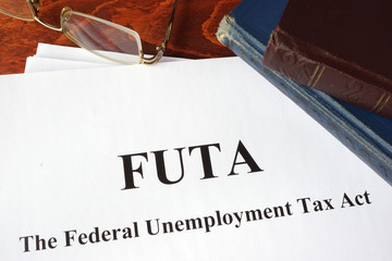 Papers with FUTA Federal Unemployment Tax Act. - obrazy, fototapety, plakaty