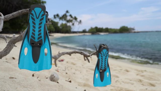 Snorkel vacation travel holidays concept with snorkeling fins on beach. Blue flippers snorkel equipment on. Tropical beach getaway vacation. Watersport fun activity: snorkeling.