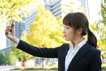 Young business woman walking on street